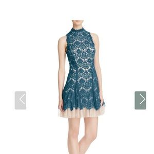 Worn once beautiful dress for cocktails or party.  Turquoise lace with tulle
